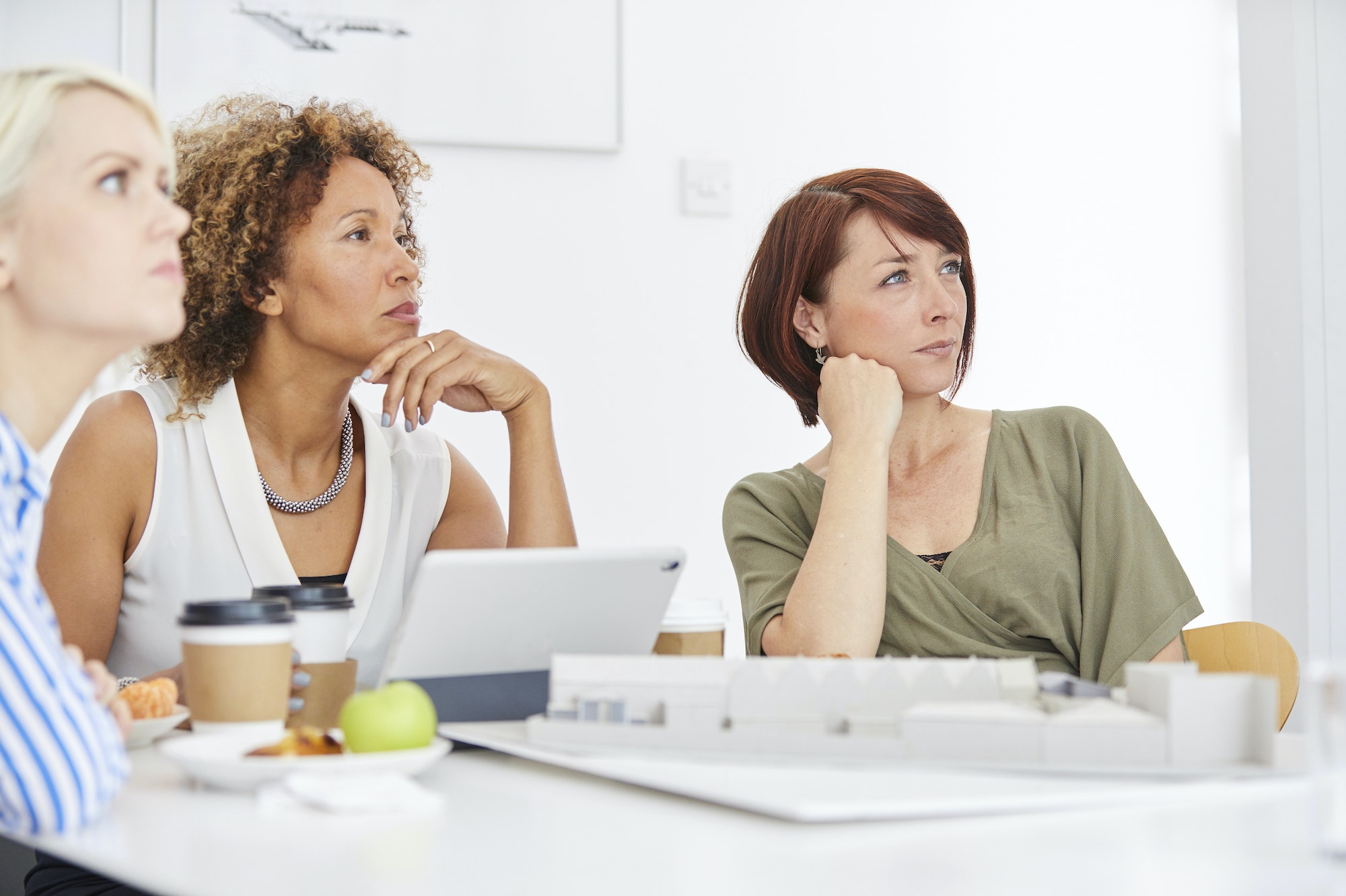 Female architect team listening during meeting